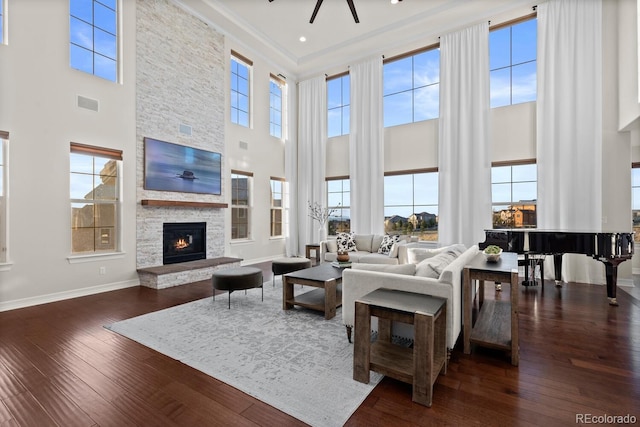 771 Braesheather Pl, Highlands Ranch, CO 80126 - living room featuring baseboards, a fireplace, wood-type flooring, and a high ceiling