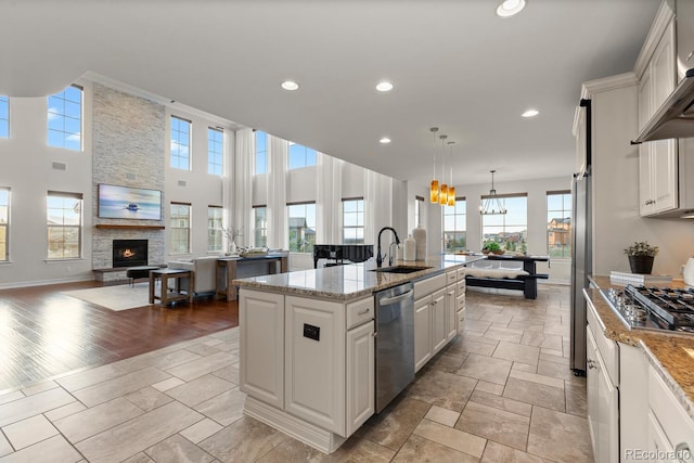 771 Braesheather Pl, Highlands Ranch, CO 80126 - kitchen featuring a sink, a wealth of natural light, a notable chandelier, and appliances with stainless steel finishes