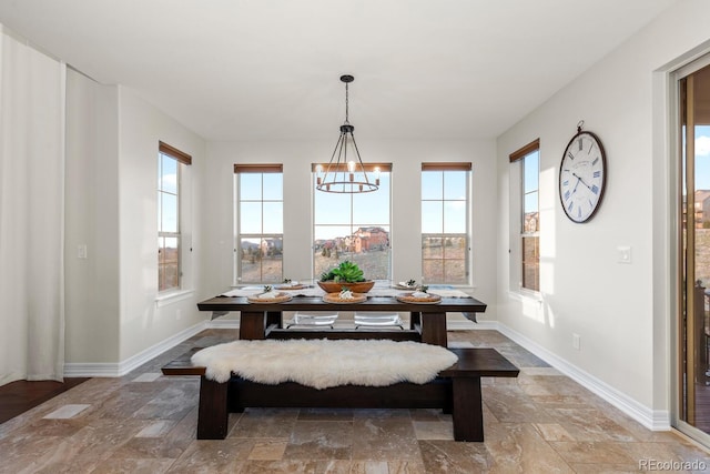 771 Braesheather Pl, Highlands Ranch, CO 80126 - dining room featuring baseboards, a notable chandelier, and stone tile floors