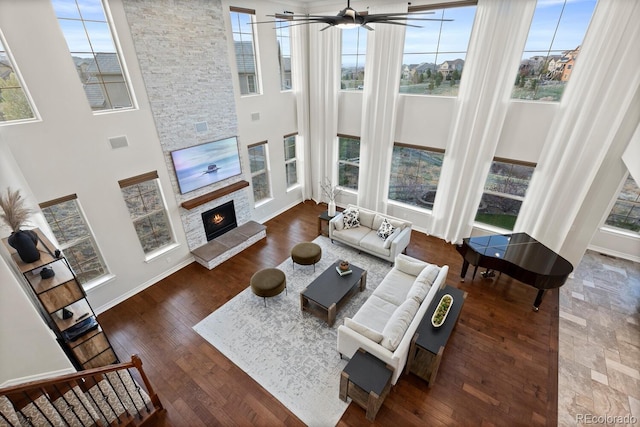 771 Braesheather Pl, Highlands Ranch, CO 80126 - living room featuring a fireplace, a high ceiling, baseboards, and wood finished floors