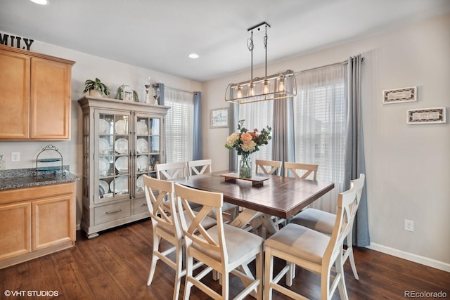 dining space with dark wood-type flooring