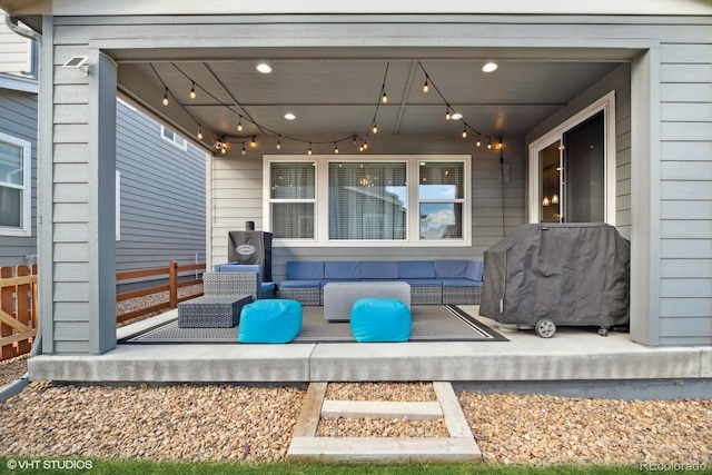 wooden terrace with an outdoor living space and area for grilling