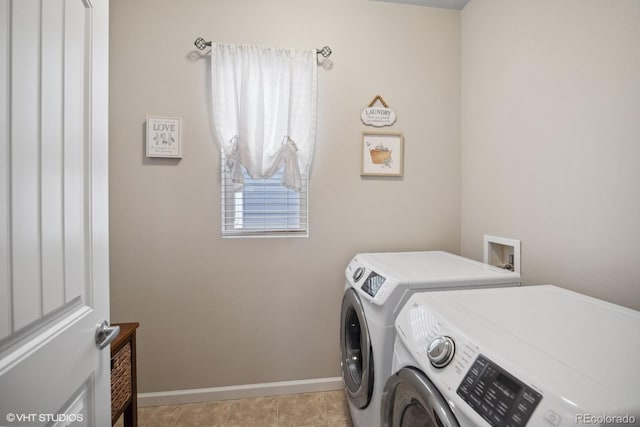 laundry room featuring washer and clothes dryer and light tile patterned floors