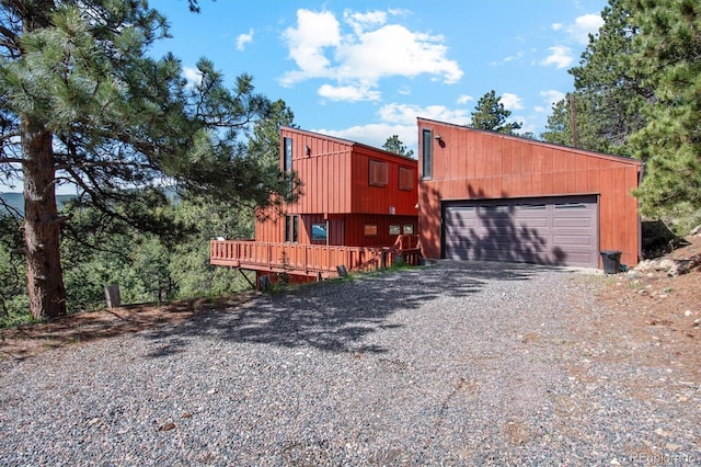 1278 Aspen Dr, Evergreen, CO 80439 - view of front of property with driveway, a wooden deck, and an attached garage