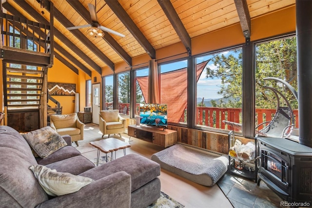 1278 Aspen Dr, Evergreen, CO 80439 - sunroom with a wood stove, wood ceiling with exposed beams, and high vaulted ceiling