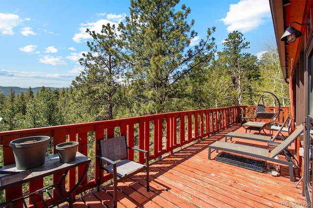 1278 Aspen Dr, Evergreen, CO 80439 - wooden deck featuring a forest view