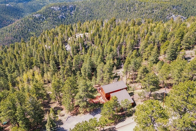 1278 Aspen Dr, Evergreen, CO 80439 - view of subject property featuring a heavily wooded area and a mountain backdrop
