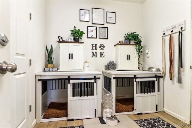 interior space with baseboards and wood finished floors