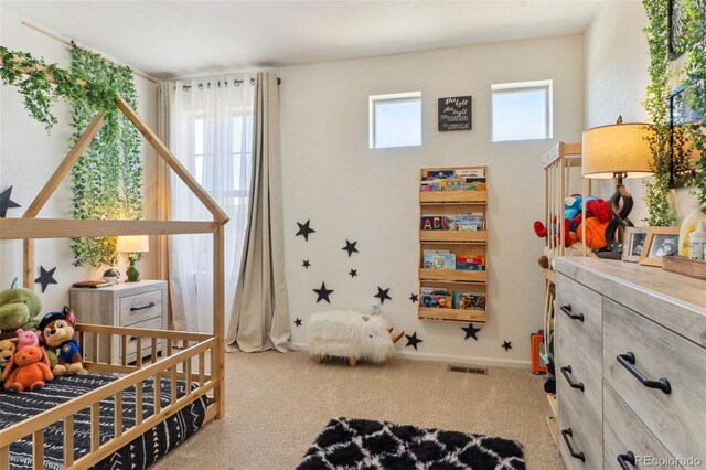 bedroom with multiple windows, visible vents, and carpet flooring