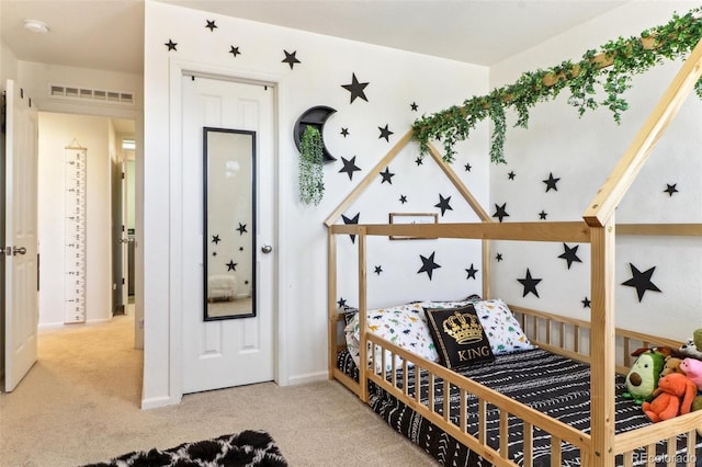 carpeted bedroom with baseboards and visible vents