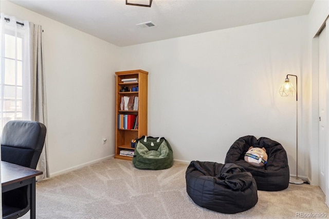 sitting room featuring carpet floors, visible vents, and baseboards