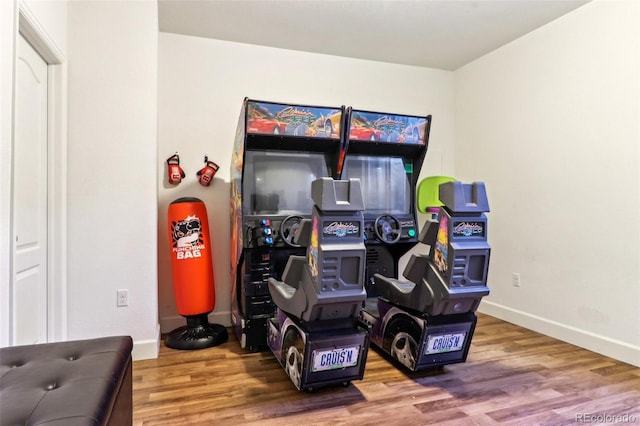 recreation room with baseboards and wood finished floors