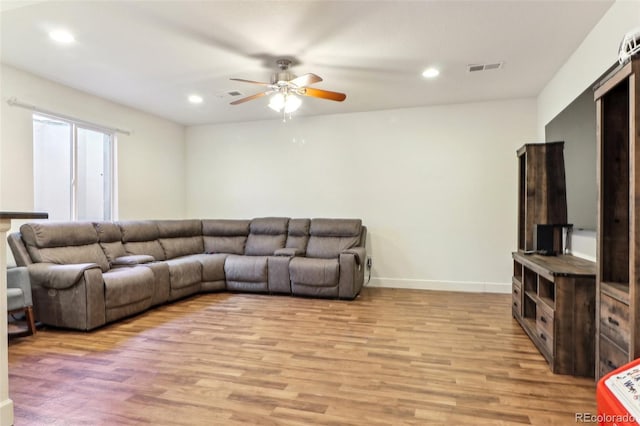 living area with light wood-style floors, visible vents, and recessed lighting