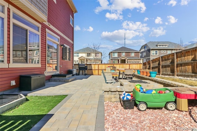 view of patio / terrace featuring a residential view and a fenced backyard