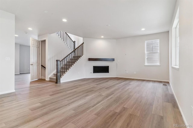 unfurnished living room with light hardwood / wood-style floors