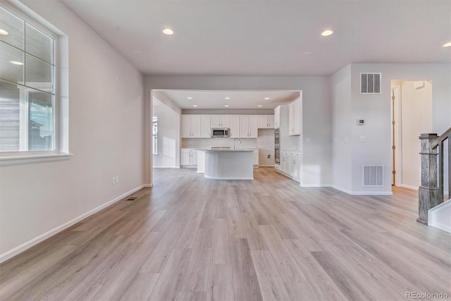 unfurnished living room with light hardwood / wood-style flooring