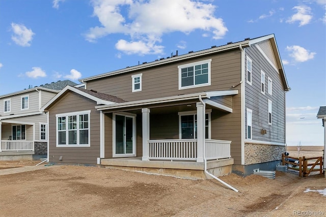 rear view of property with covered porch