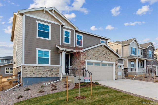 craftsman inspired home featuring a garage and a front lawn