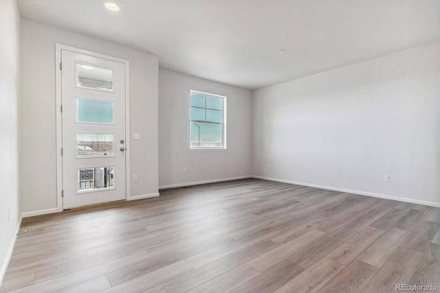 spare room featuring light hardwood / wood-style floors