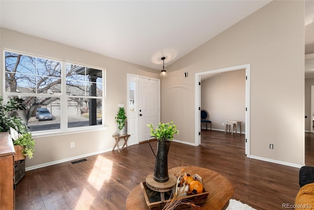 foyer entrance with visible vents, lofted ceiling, baseboards, and wood finished floors