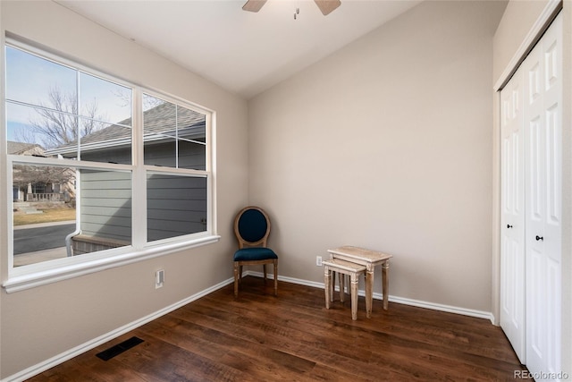 interior space featuring visible vents, wood finished floors, baseboards, lofted ceiling, and ceiling fan