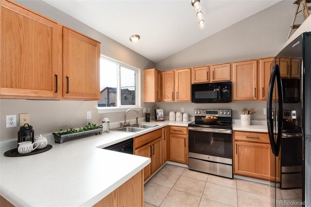 kitchen featuring a sink, black appliances, vaulted ceiling, and light countertops