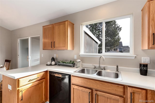 kitchen featuring dishwasher, light countertops, a peninsula, and a sink