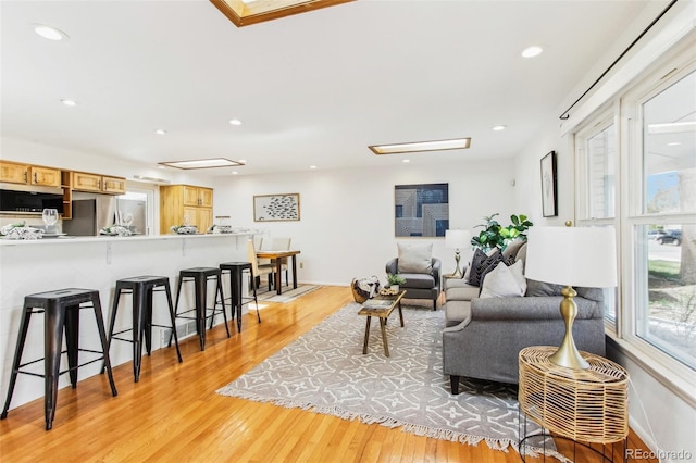 living area featuring recessed lighting and light wood-style floors