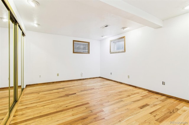 interior space featuring baseboards, light wood-style flooring, and visible vents