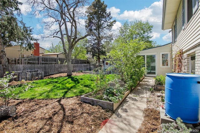 view of yard with fence and a garden