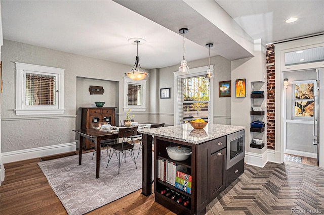 1419 N Adams St, Denver, CO 80206 - kitchen with stainless steel microwave, baseboards, open shelves, dark brown cabinetry, and pendant lighting