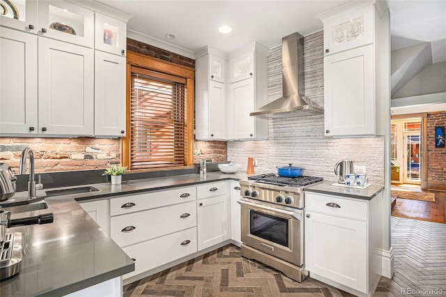 1419 N Adams St, Denver, CO 80206 - kitchen with wall chimney range hood, stainless steel range, tasteful backsplash, white cabinetry, and recessed lighting