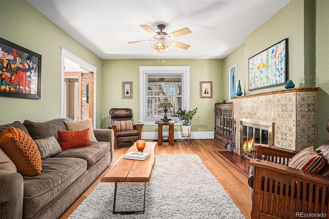 1419 N Adams St, Denver, CO 80206 - living room featuring wood finished floors, ceiling fan, and a tiled fireplace