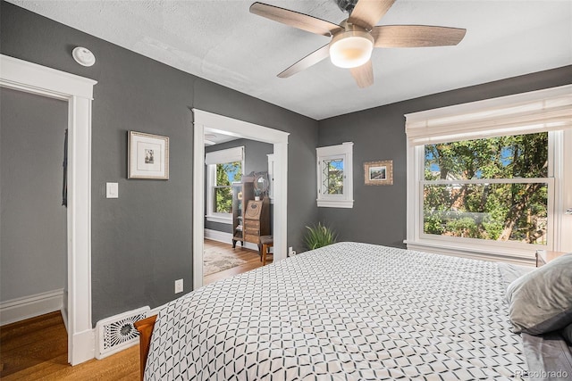 1419 N Adams St, Denver, CO 80206 - bedroom with light wood-style flooring and a ceiling fan