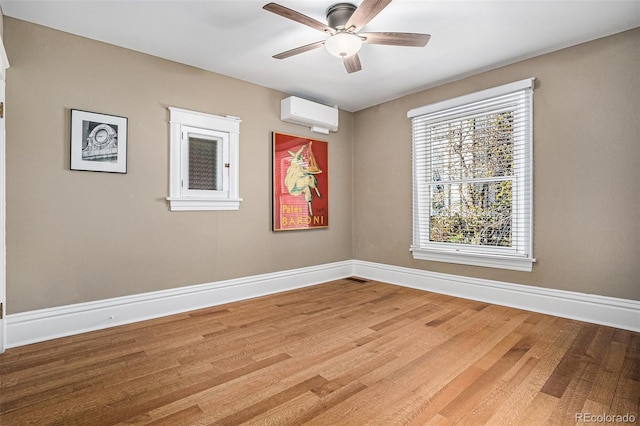 1419 N Adams St, Denver, CO 80206 - empty room featuring a wall mounted AC, wood finished floors, and a ceiling fan