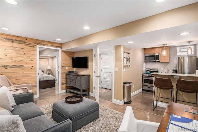 1419 N Adams St, Denver, CO 80206 - living room featuring wooden walls, recessed lighting, and finished concrete flooring