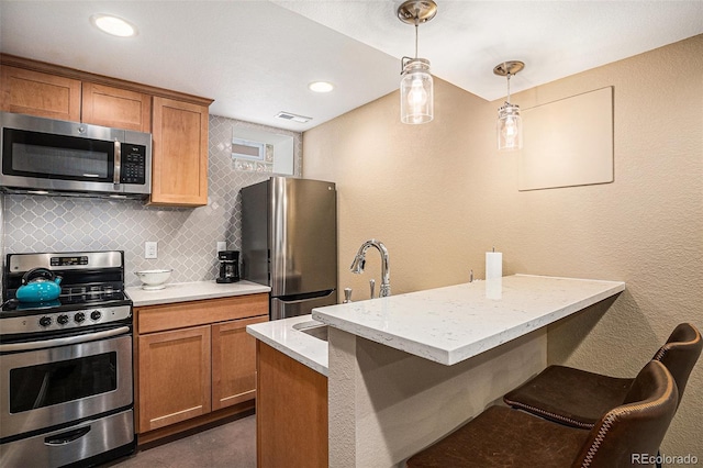 1419 N Adams St, Denver, CO 80206 - kitchen featuring stainless steel appliances, brown cabinets, decorative light fixtures, decorative backsplash, and a peninsula