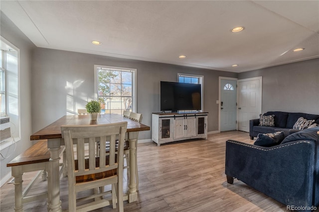 living room with light hardwood / wood-style floors and ornamental molding