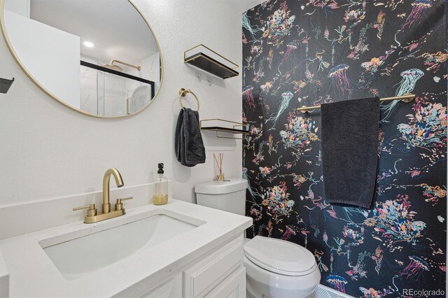8981 E Amherst Dr Unit E, Denver, CO 80231 - full bathroom featuring toilet, vanity, and a shower with shower door
