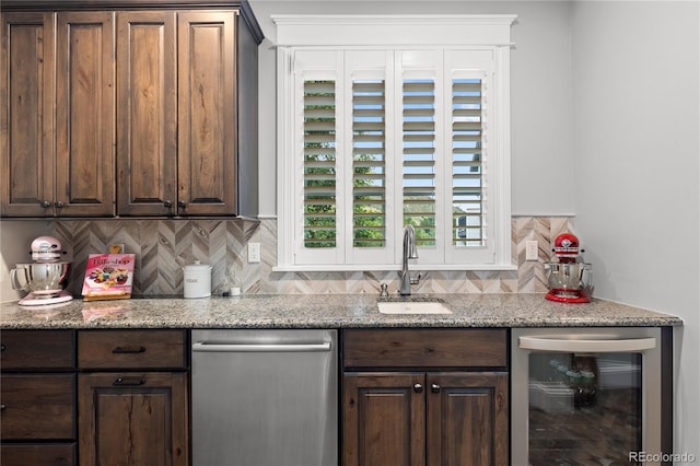 8326 Raphael Ln, Littleton, CO 80125 - kitchen featuring stainless steel dishwasher, wine cooler, tasteful backsplash, dark brown cabinets, and light stone countertops