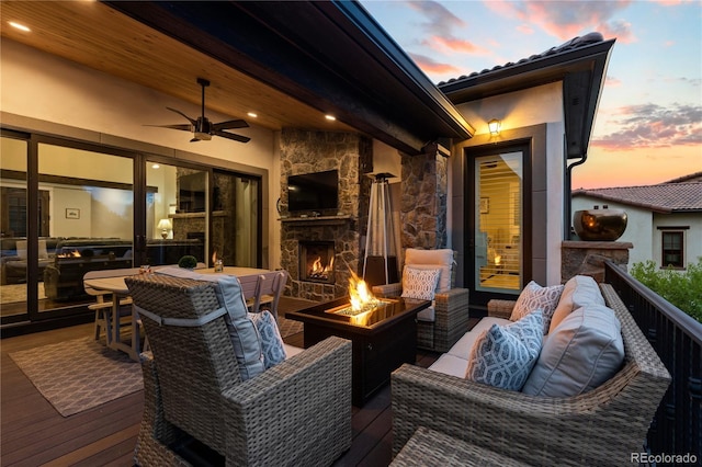 8326 Raphael Ln, Littleton, CO 80125 - deck featuring an outdoor living space with a fireplace and a ceiling fan