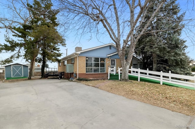 view of front facade with a storage shed