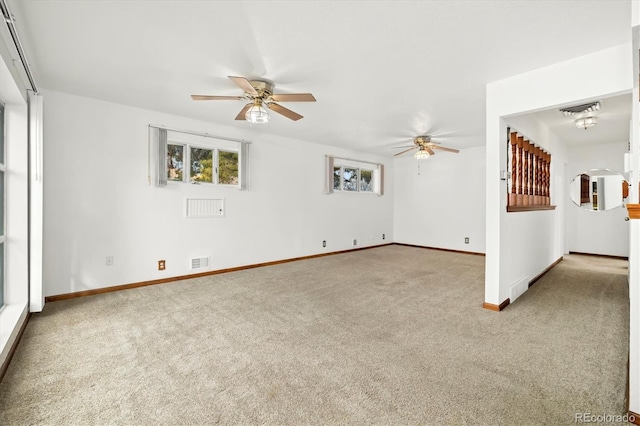 empty room with carpet, plenty of natural light, and ceiling fan