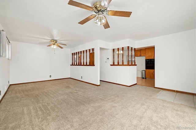 unfurnished living room with light colored carpet and ceiling fan