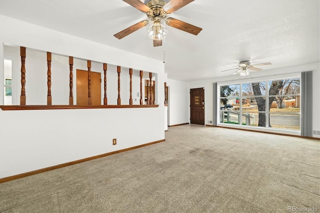 unfurnished living room featuring ceiling fan and carpet floors