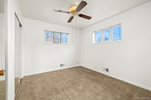 unfurnished bedroom featuring ceiling fan, carpet flooring, and a closet