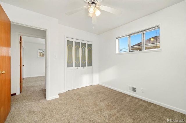 unfurnished room with ceiling fan and light colored carpet