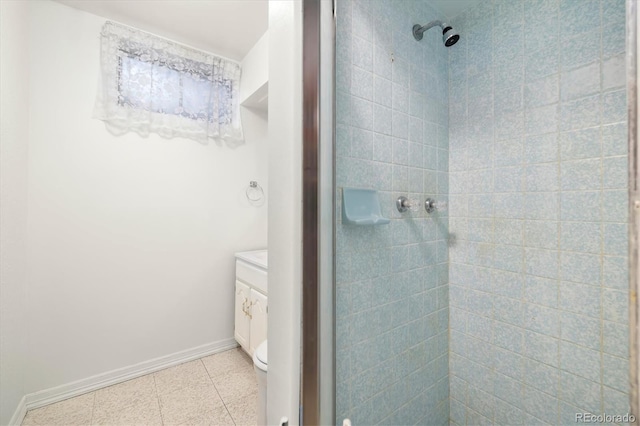 bathroom with vanity, toilet, tile patterned flooring, and a tile shower