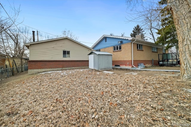 back of property with a storage shed