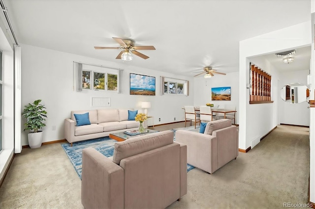 living room featuring ceiling fan and light colored carpet